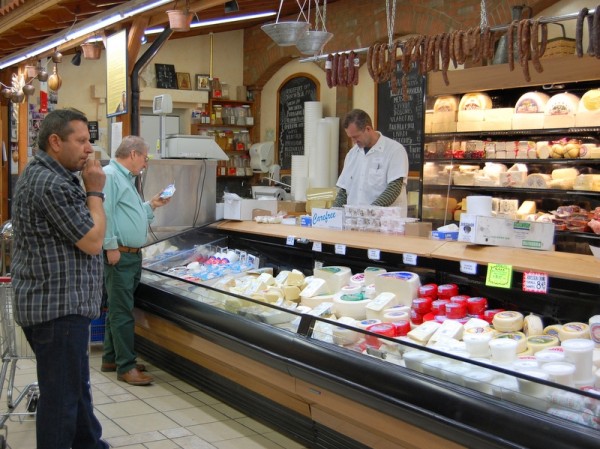 Titan's cheese counter is a fromage-lover's paradise. Loukaniko, the traditional air-dried pork sausages dangling above, are typically flavored with orange peel and fennel seed.